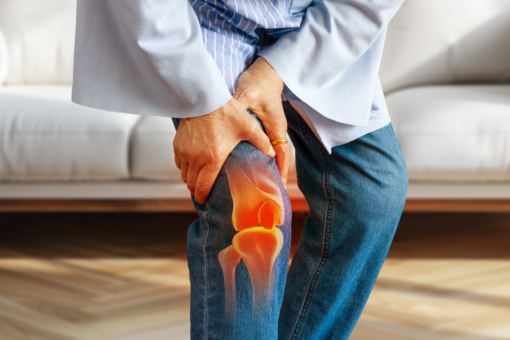 Person holding knee in pain